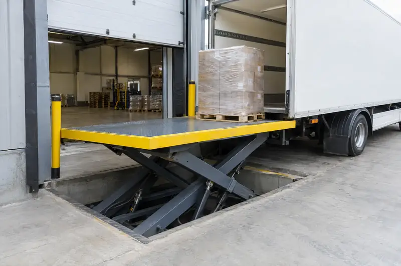 Scissor lift table raised to trailer height at a ground-level warehouse door